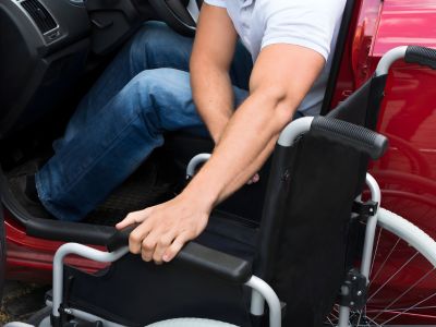 Disabled Driver in St. Petersburg, FL Entering a Car with Hand Controls